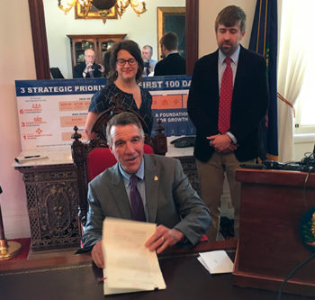 Gov. Phil Scott signs Vermont’s new shield law for journalists and their sources. Behind Scott, freelance journalists Hilary Niles and Dave Gram flank Paul Heintz of Seven Days of Burlington, Vt., a member of the Vermont Press Association board. They were part of a coalition of journalists that supported a call by the press association for a shield law.