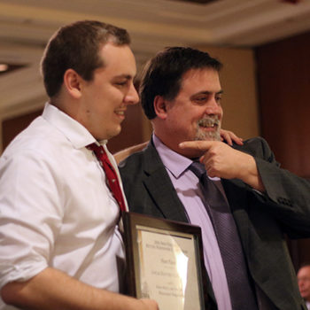 Walter Bird Jr., the New England Newspaper and Press Association’s Weekly Reporter of the Year, points to a fellow award winner at NENPA’s winter convention.
Bulletin photo by Kareya Saleh