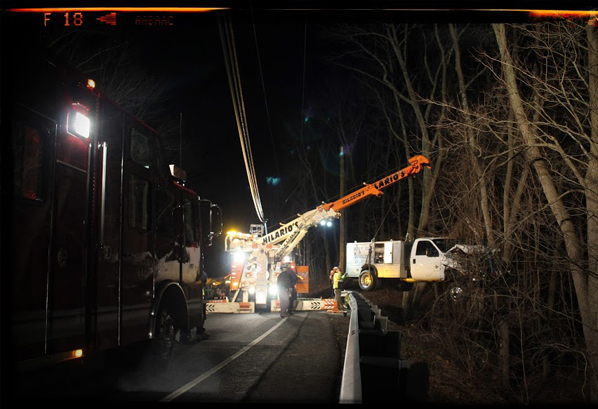 This photo of a truck being extricated after going over a guardrail in Sandy Hook is an example of Shannon Hicks’ spot news photography. Photo by Shannon Hicks photo, courtesy of The Newtown (Conn.) Bee