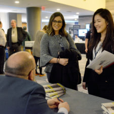 Jason Rezaian, keynote speaker, chats with Emerson journalism students Caroline Broderick and Frances Hui after autographing Frances’ book.   Boston Renaissance Waterfront Hotel.