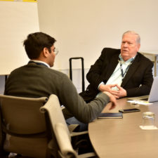 Bob Holt, talks with Utsav Gupta of Olin College in Needham during a one on one session at the New England Newspaper Convention, 2019.